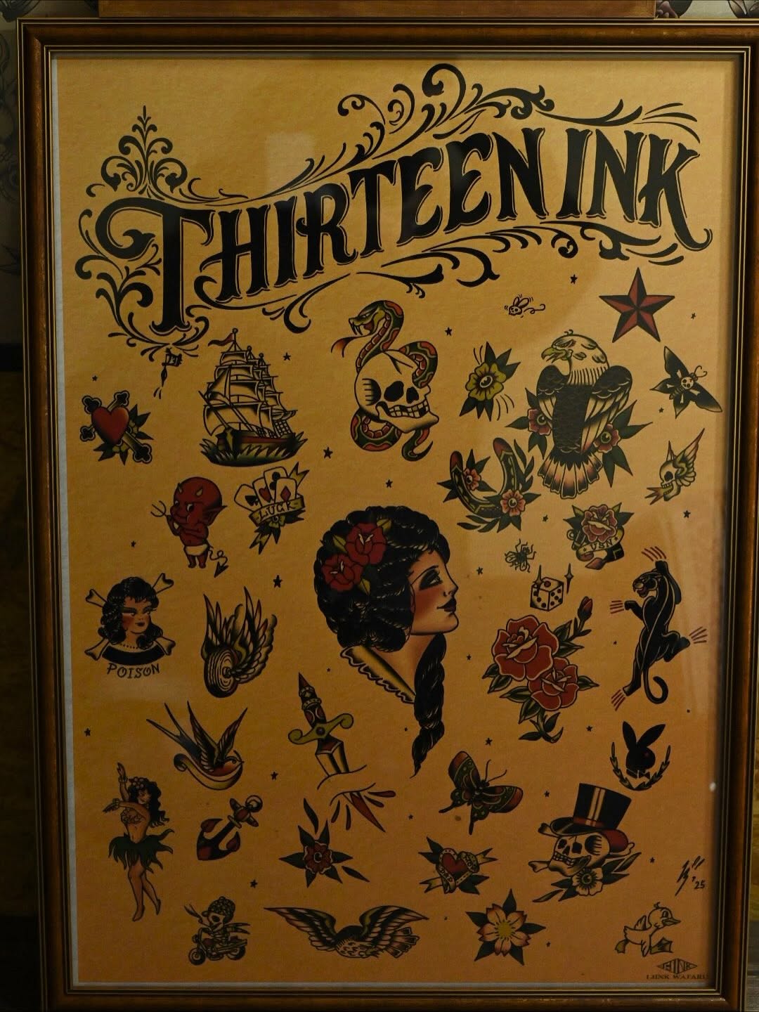 Framed vintage flash sheet titled "Thirteen Ink" featuring a woman's profile surrounded by nautical, floral, and symbolic tattoo designs in black and red on tan paper.