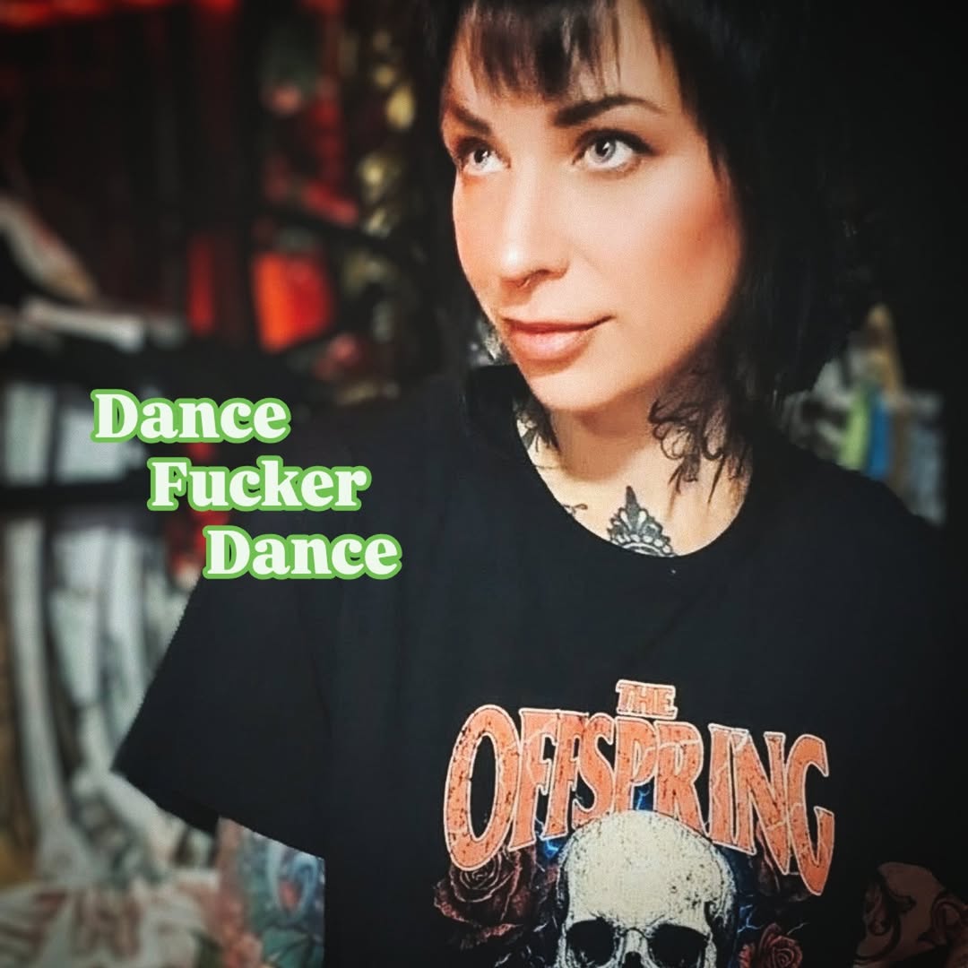 Person wearing black Offspring band shirt displaying a shoulder tattoo of a skull with decorative elements in dark ink.