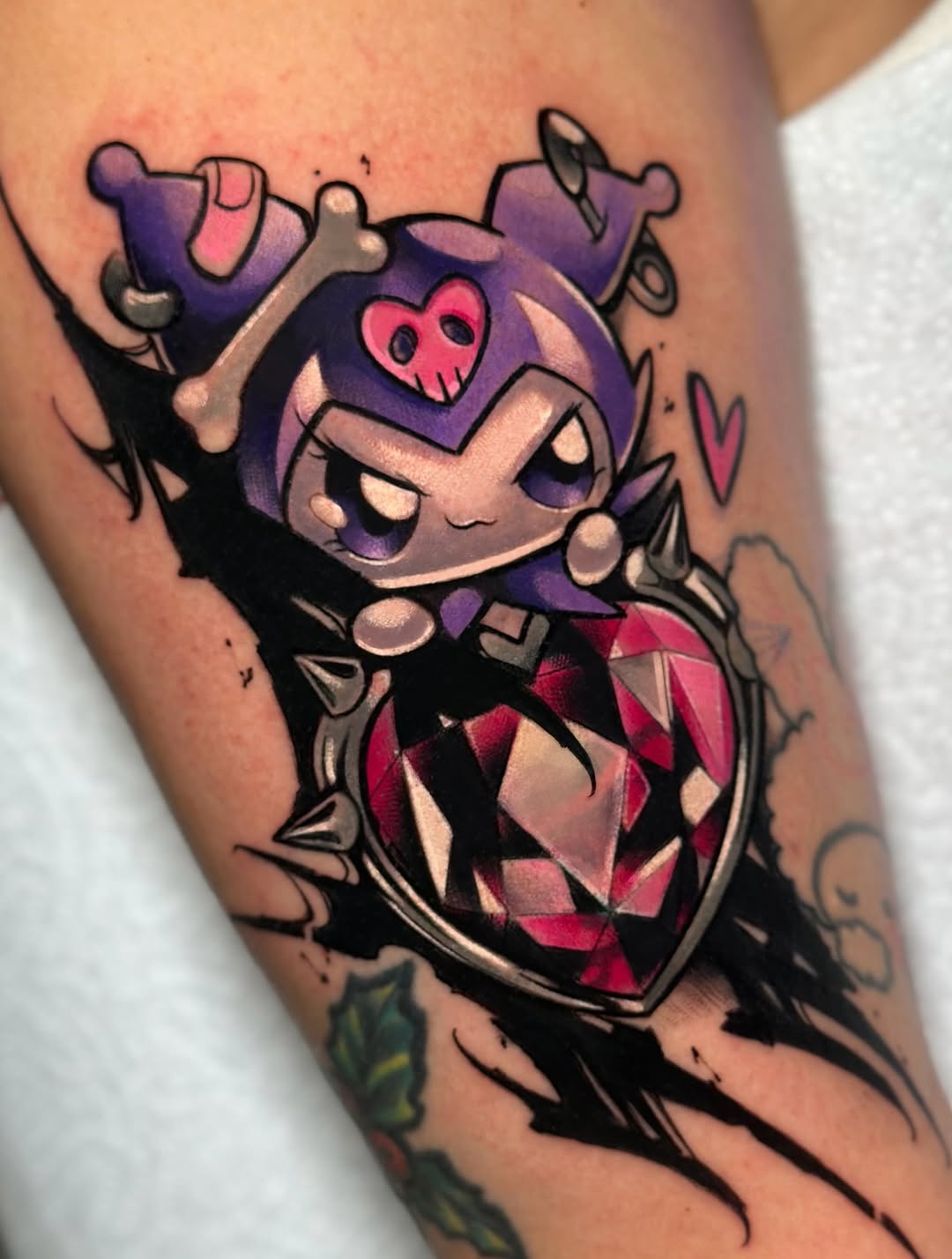 Purple-headed character with pink skull chest emblem and red diamond-patterned body on upper arm, surrounded by black linework and bone elements.