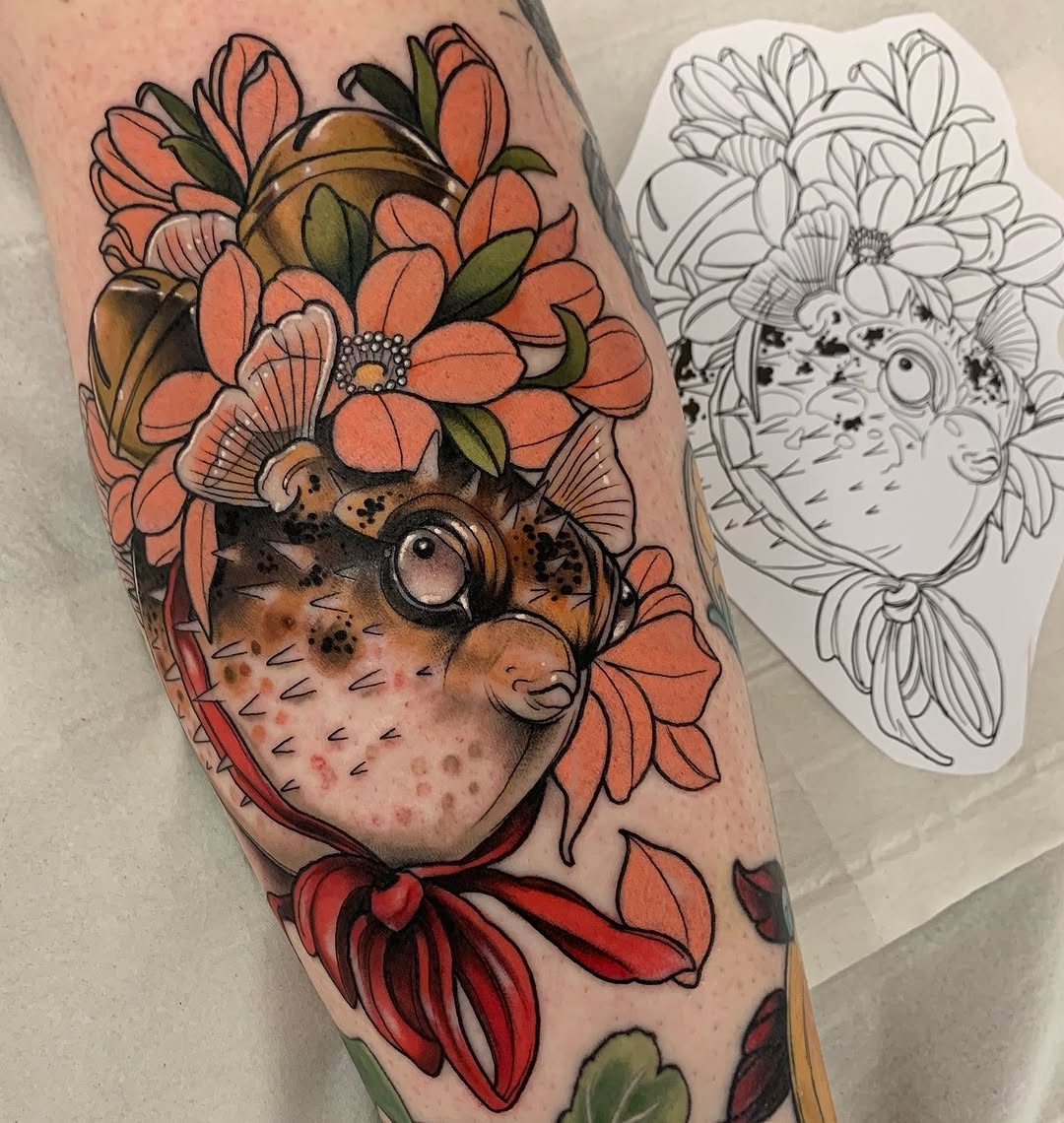 Colorful tattoo on leg featuring a hedgehog surrounded by orange and red flowers with green leaves, accompanied by a sketch reference design.