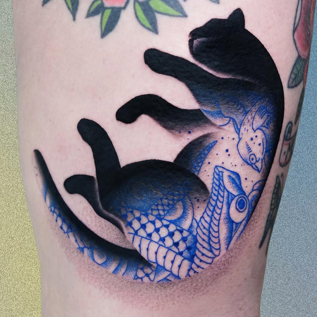A mermaid tail with black upper body and blue-scaled lower half featuring decorative patterns wraps around the upper leg and thigh.
