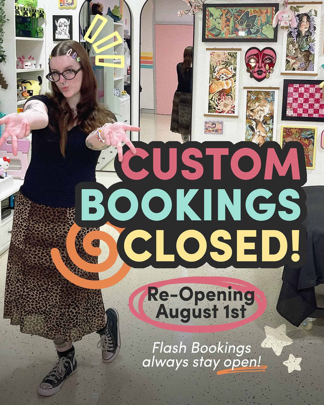 Tattoo artist holding pink plush toys in a studio shop, wearing glasses and leopard-print skirt, with colorful artwork displayed on walls behind her.