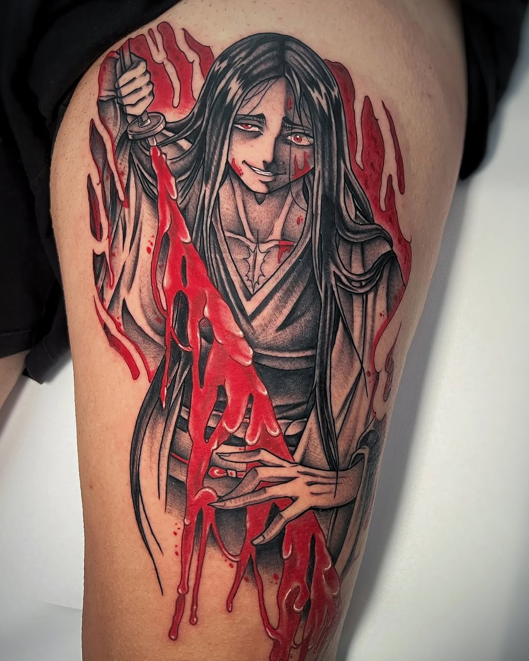 Thigh tattoo featuring a long-haired figure with red eyes holding a sword, surrounded by dripping red paint effect, rendered in black and red ink.