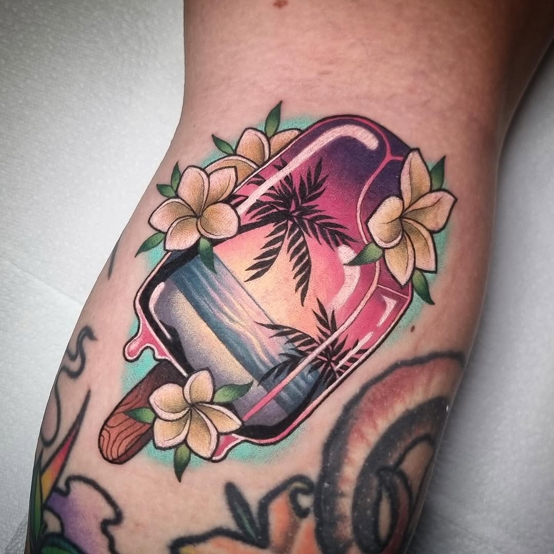 Colorful leg tattoo featuring a pink perfume bottle surrounded by cream flowers, fern leaves, and teal background elements.