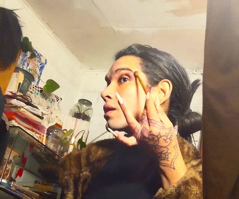 Woman displaying a decorative floral design tattoo on her inner arm featuring black linework and intricate details.