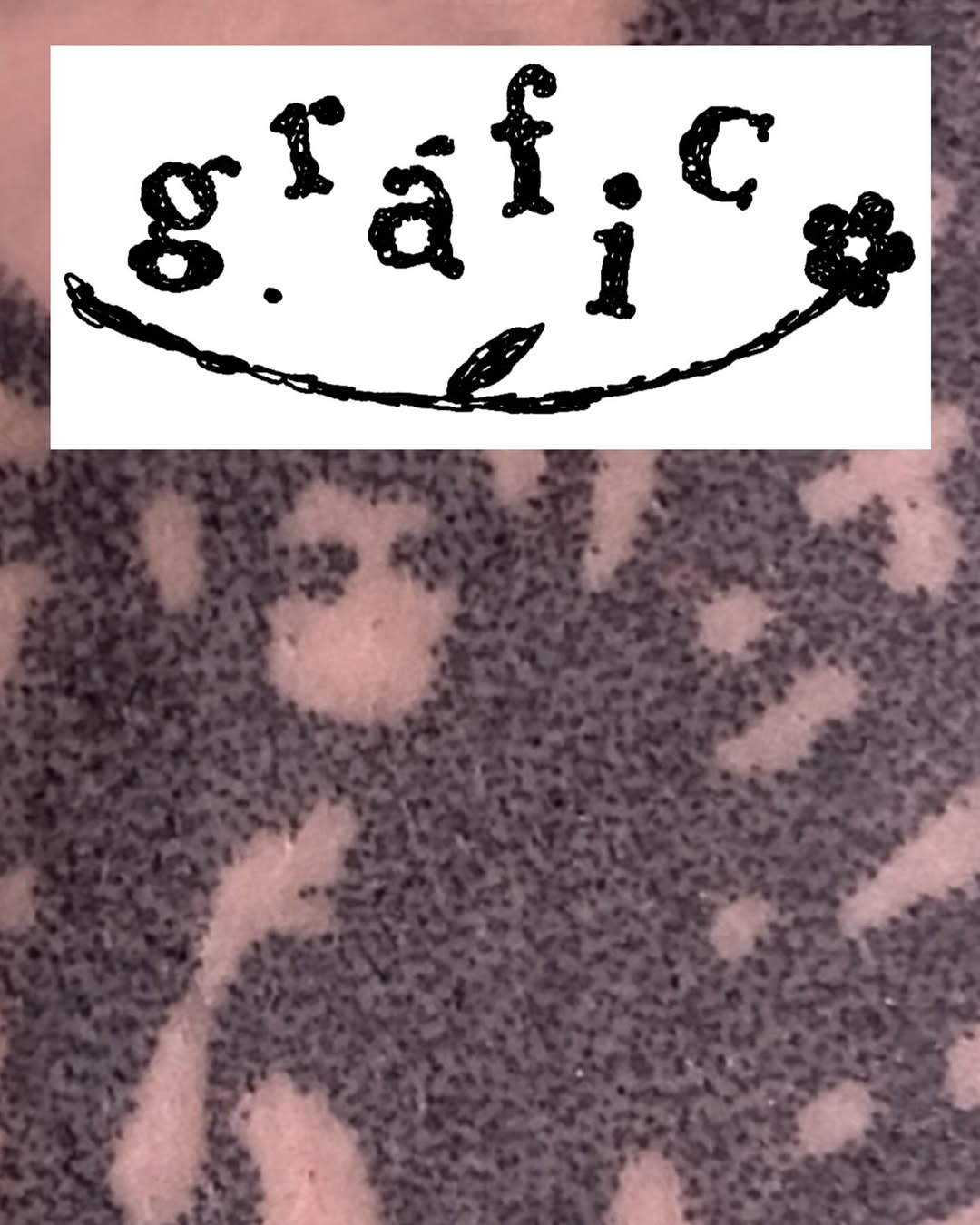 Smiley face tattoo design with text reading "g_i_s_f_i_C" above a curved line with leaf and flower elements, rendered in black ink.