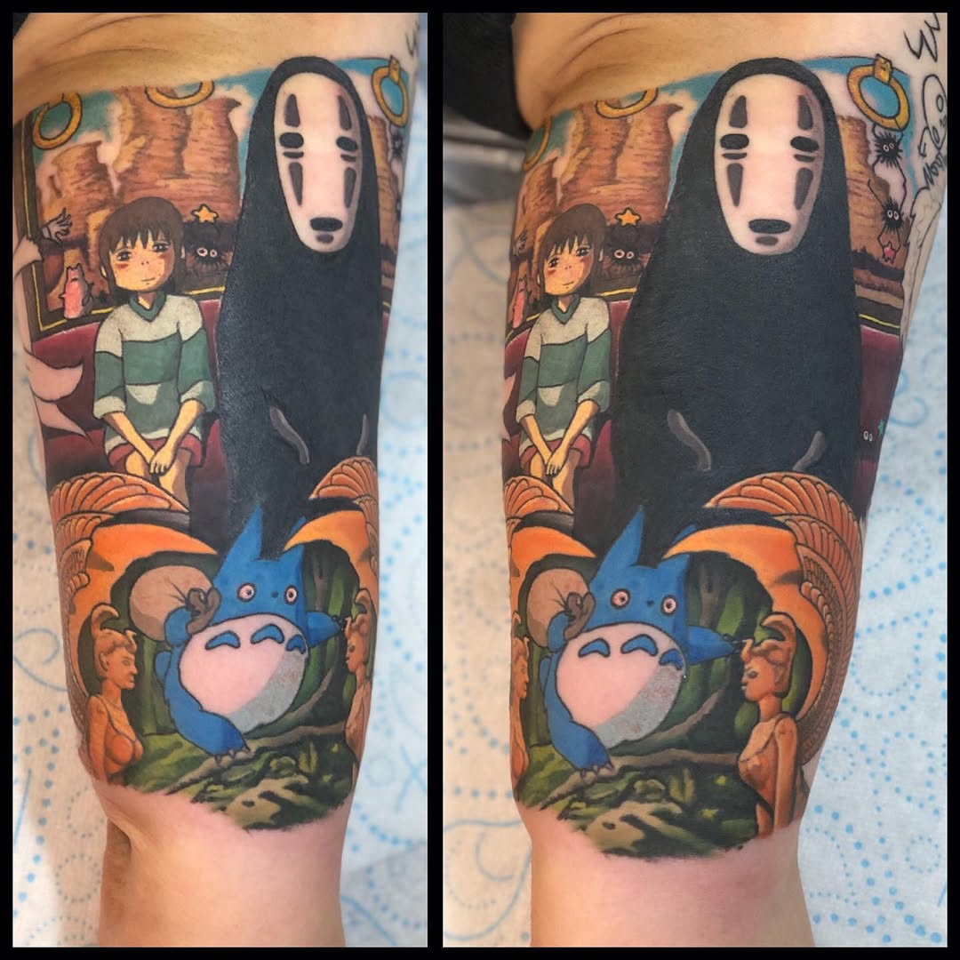 Colorful leg tattoo featuring No-Face, Chihiro, Totoro, and forest creatures in orange, blue, green, and black tones.