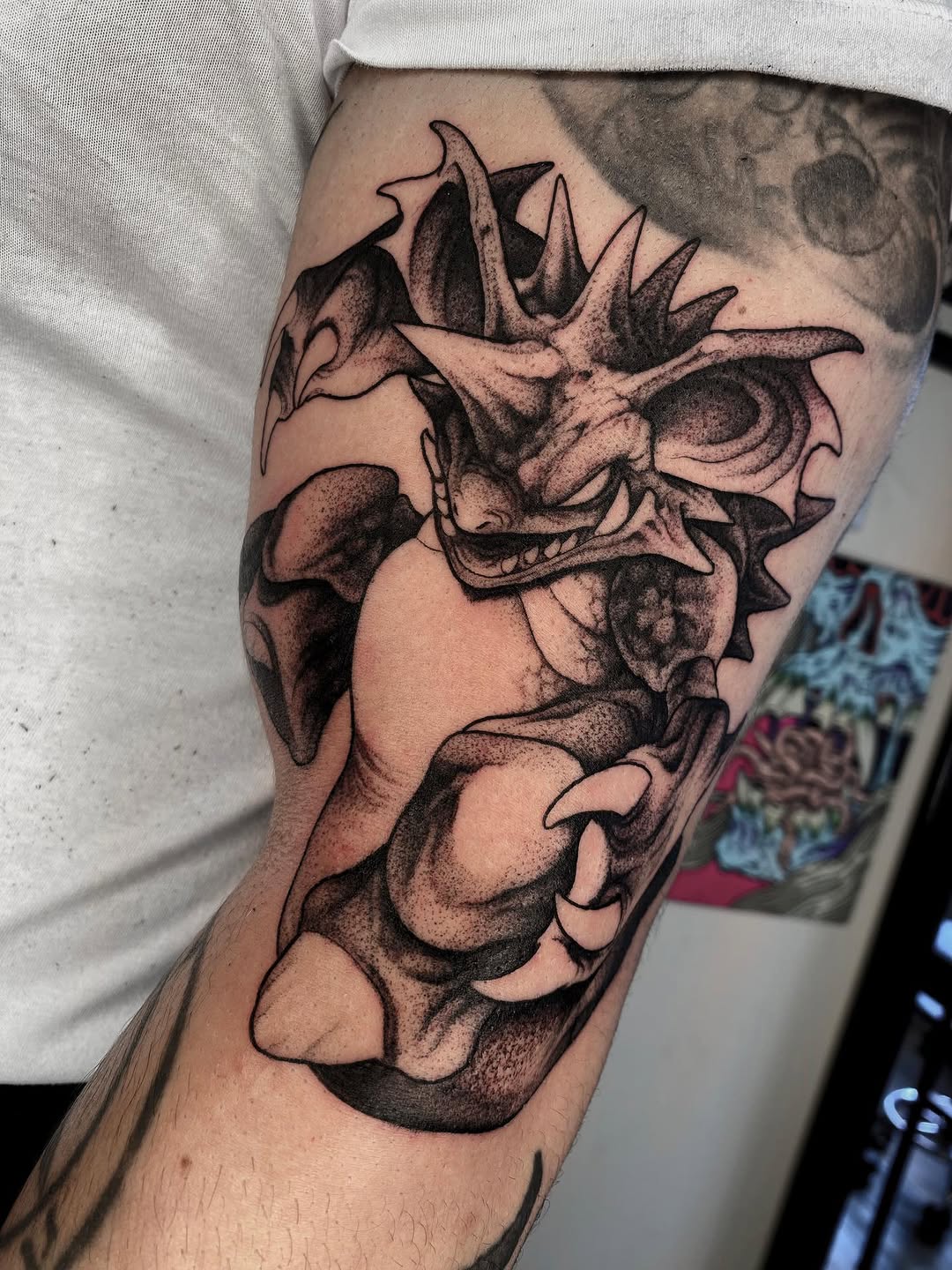 Detailed skull with spiky crown and ornate jaw design tattooed on forearm in black and brown ink with shading.