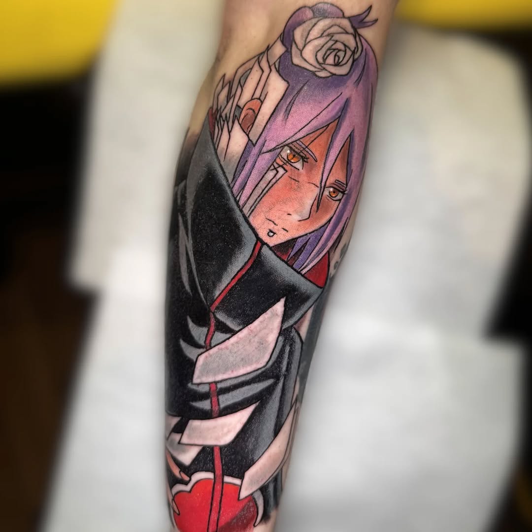 Colorful leg tattoo featuring an anime character with purple hair in a black and red outfit, with a rose above.