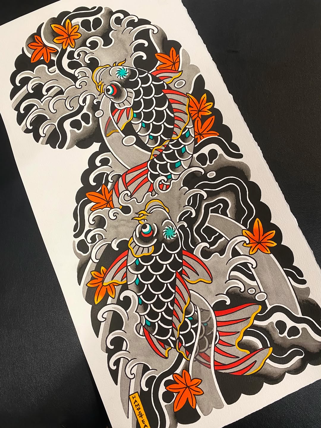 Two ornate koi fish with scaled bodies, red and yellow fins, surrounded by decorative scrollwork, clouds, and orange flowers in black, white, red, yellow, and teal on white paper.