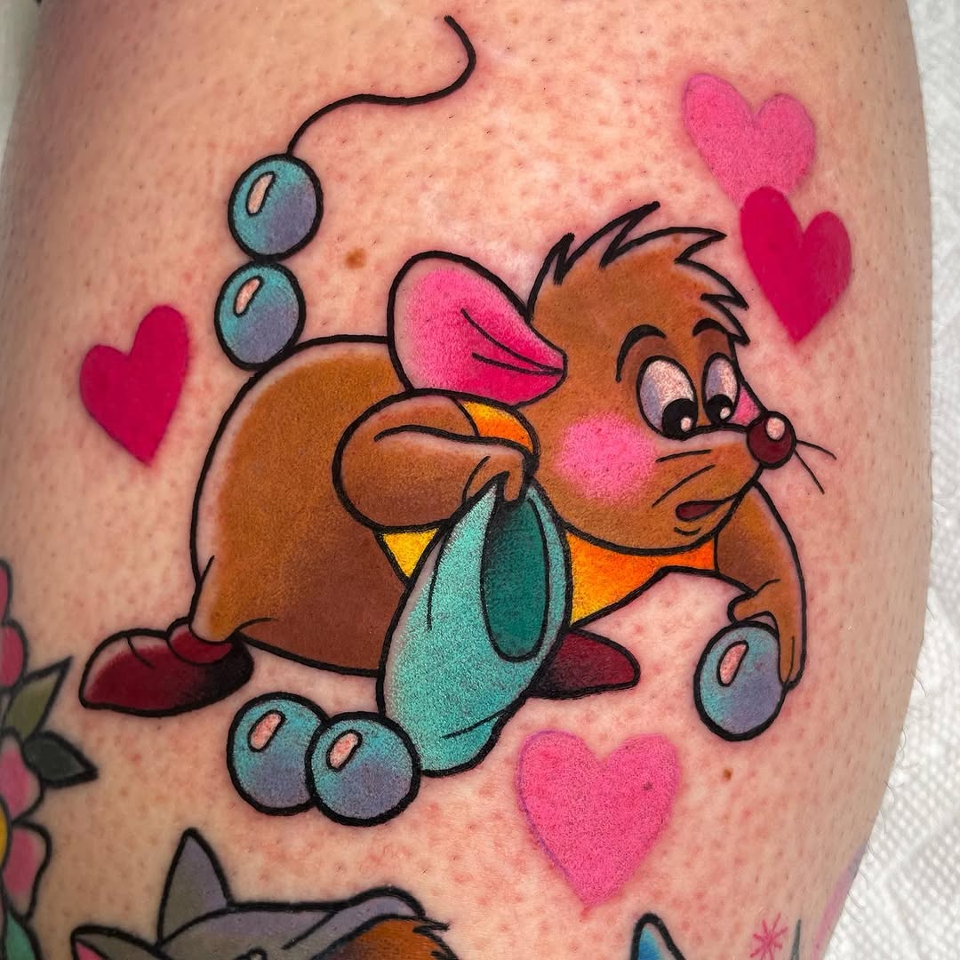 Colorful cartoon mouse character holding blueberries and a leaf on upper leg, surrounded by pink hearts and blue bubbles.
