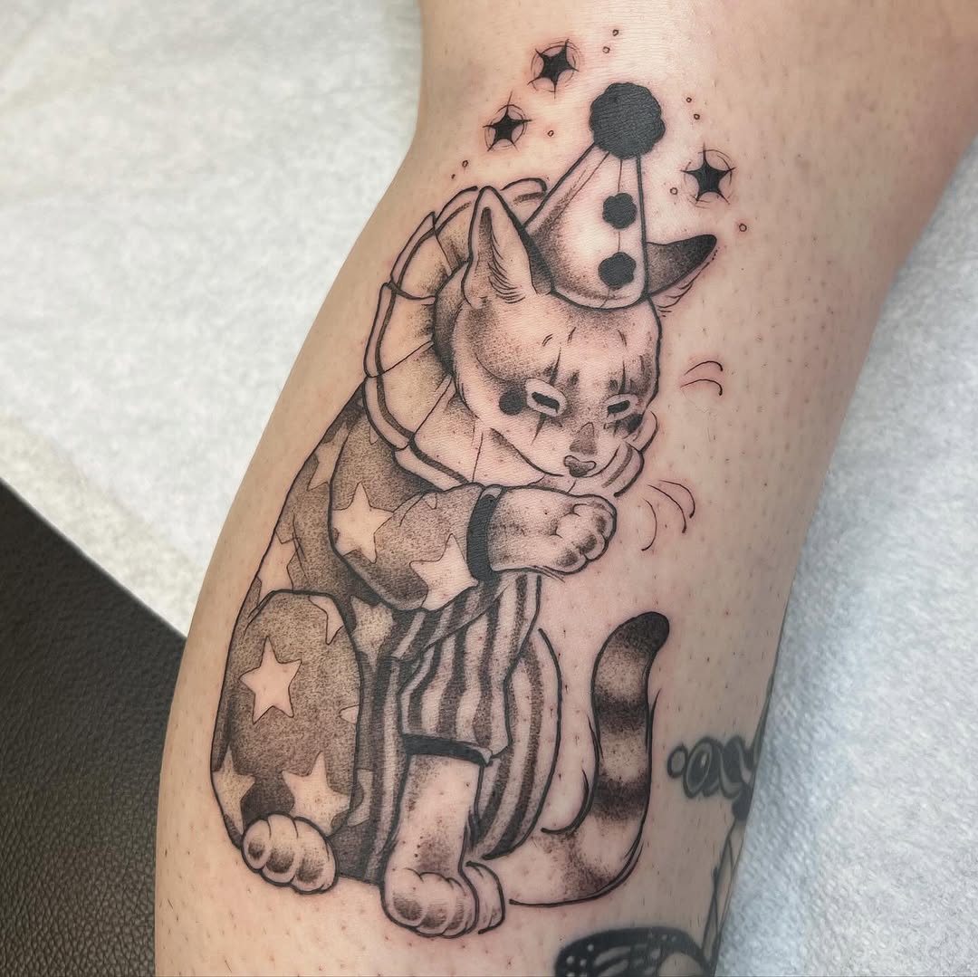 Winnie the Pooh holding a mobile constellation mobile with stars, tattooed on the calf in black ink with shading.
