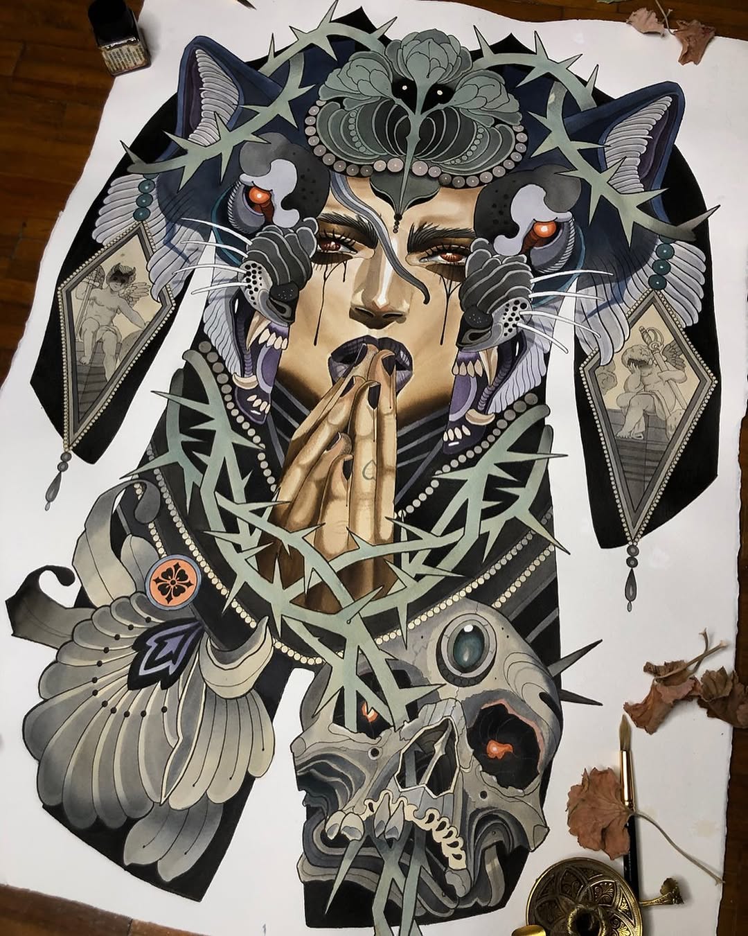 Intricate colored tattoo design featuring a central face with ornate owl and butterfly motifs, thorny vines, and decorative elements in blacks, grays, golds, and copper tones.
