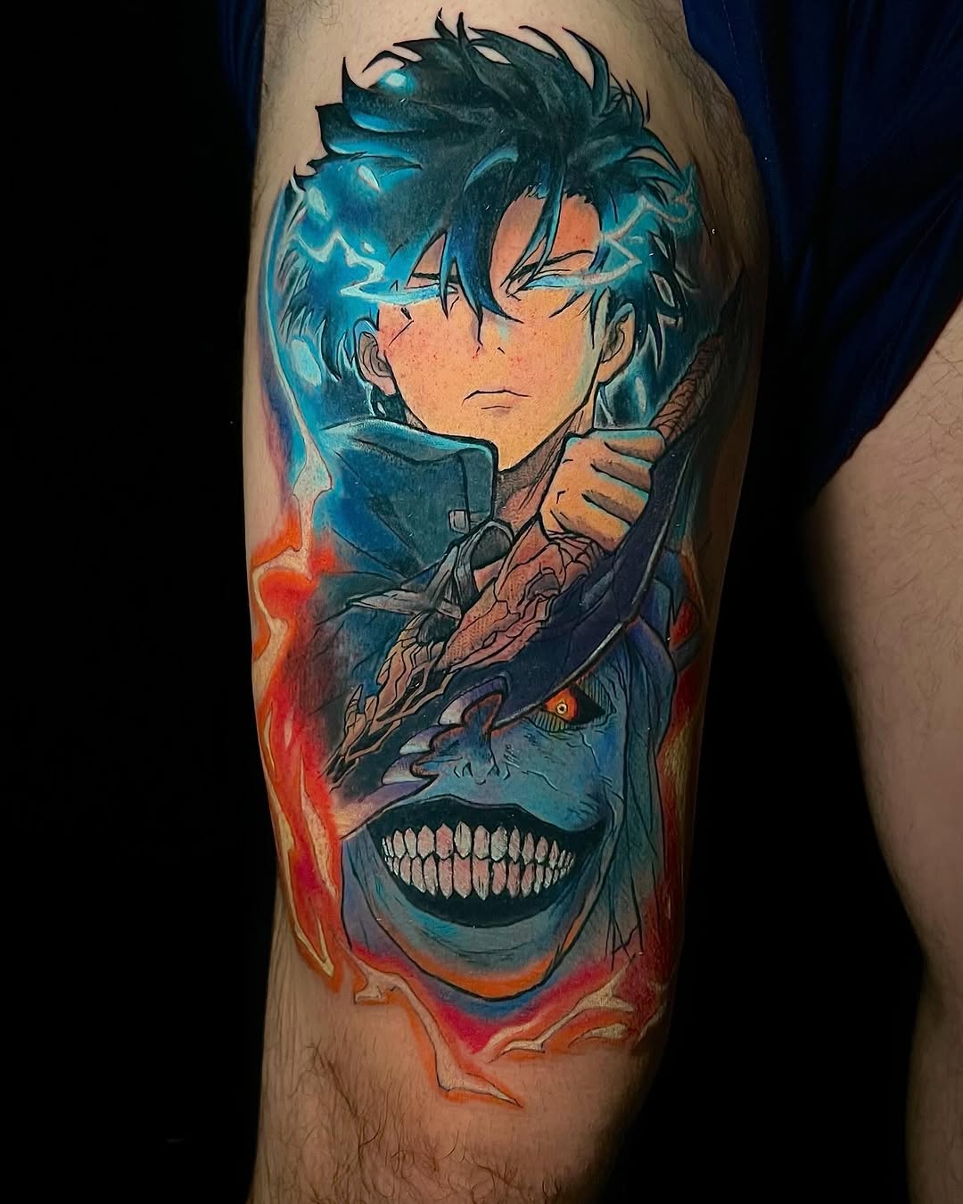 Colorful leg tattoo featuring an anime character with spiky blue hair and a demonic skull form below, surrounded by red and orange flames.