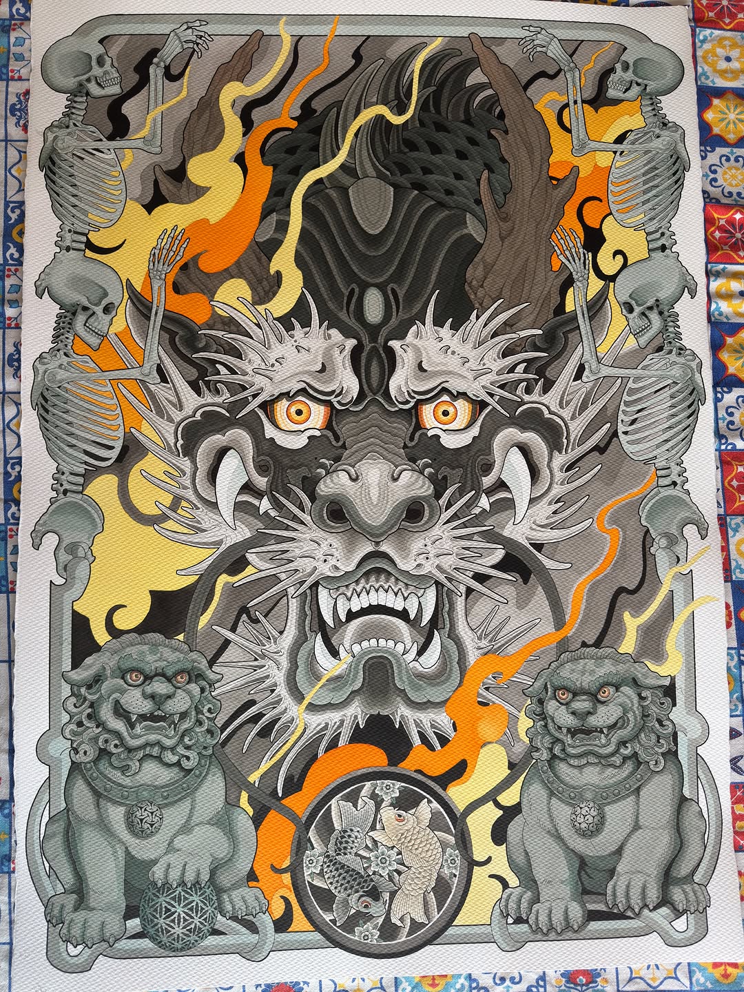 Detailed demon mask design featuring skeletal figures, ornamental lions, and flames in grey, black, orange and yellow tones.