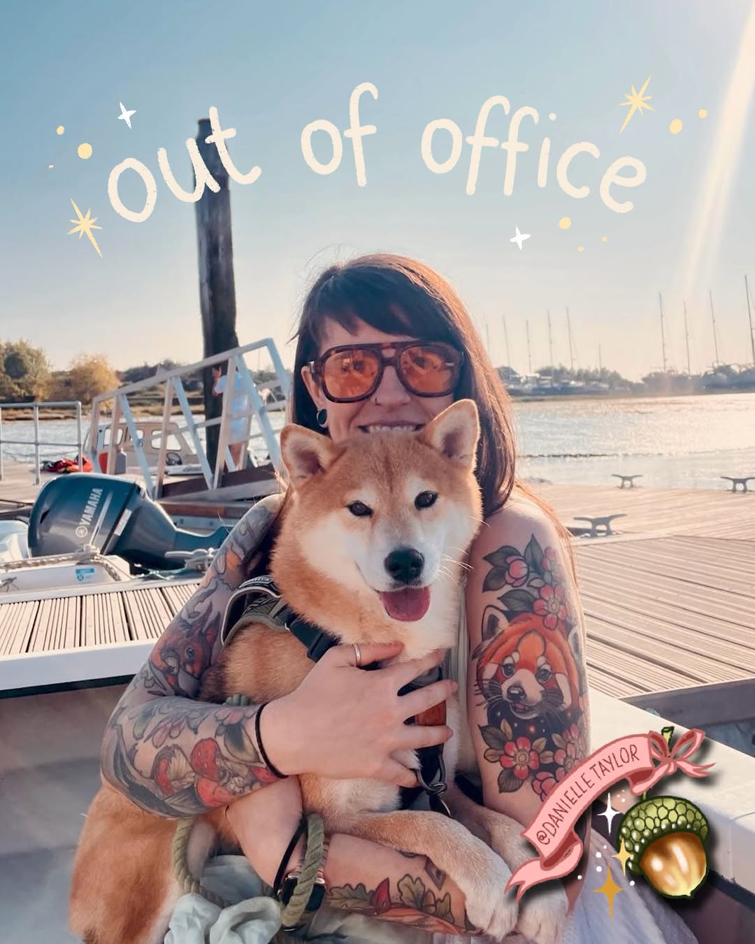 Woman with full-color floral and animal tattoos on both arms poses on a boat deck holding a smiling Shiba Inu dog.