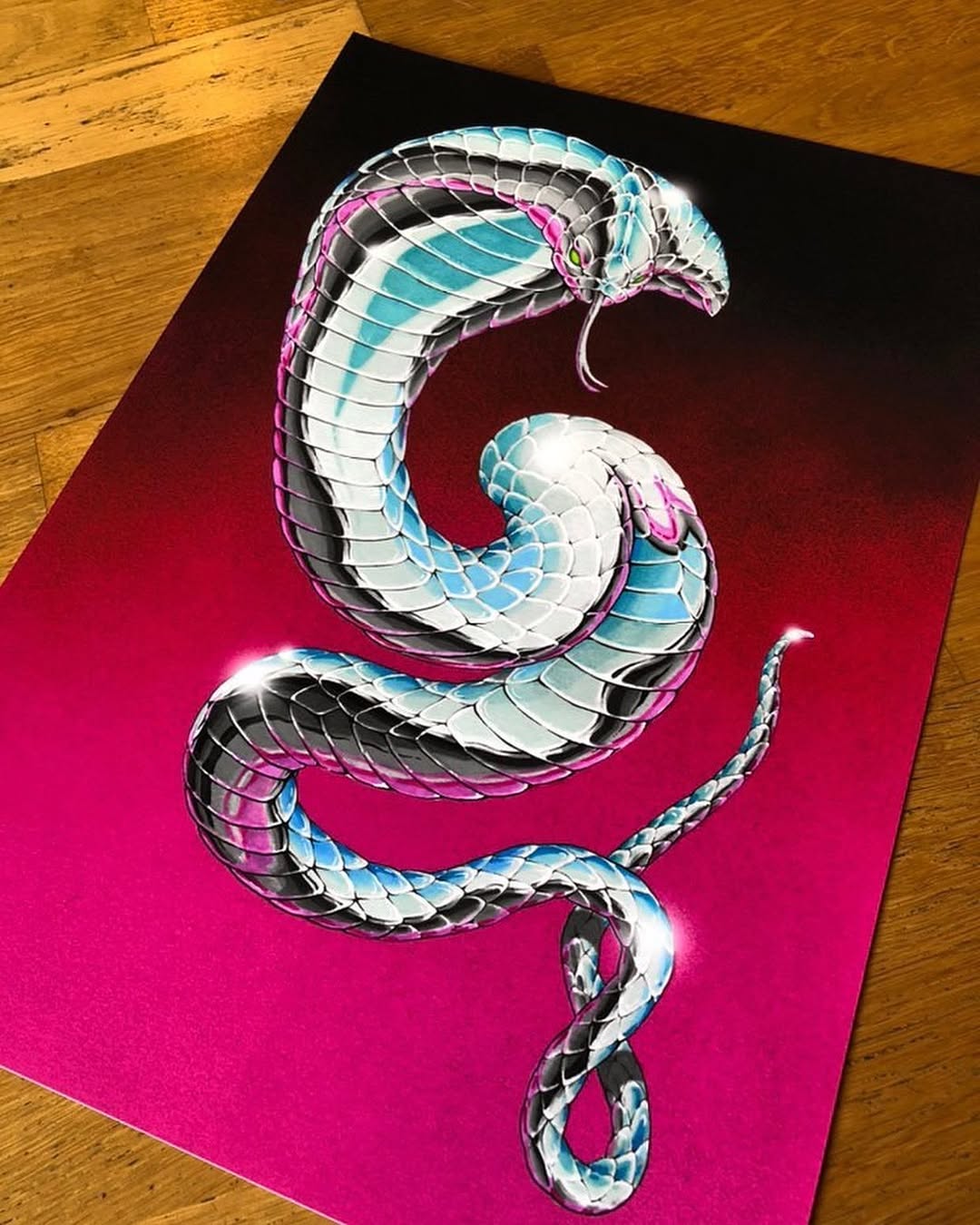 Colorful coiled cobra with turquoise, pink, and black scales on a bright pink background, shown as a portfolio drawing.