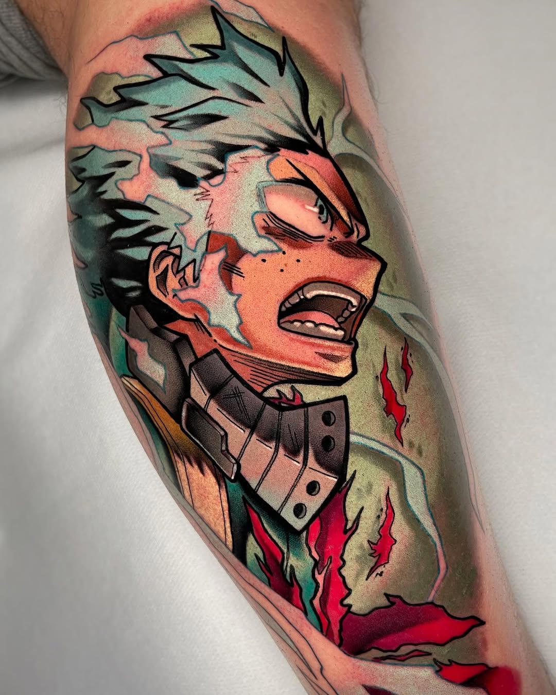 Colorful portrait tattoo on a calf featuring a person with spiky hair, open mouth, studded collar, and red flame elements against a multi-colored background.
