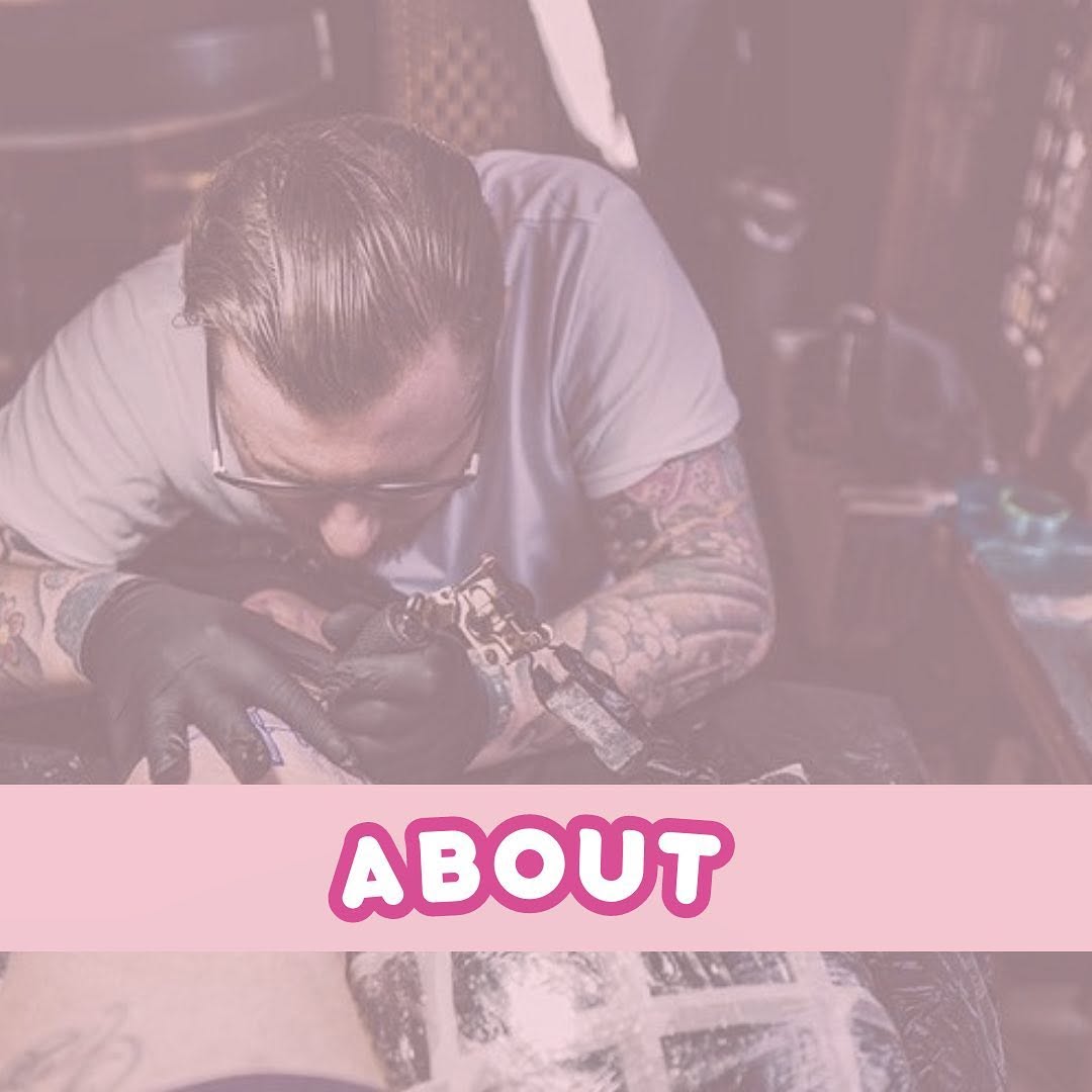 Tattoo artist working on a detailed arm piece featuring intricate designs in dark ink on a client's upper arm and shoulder.
