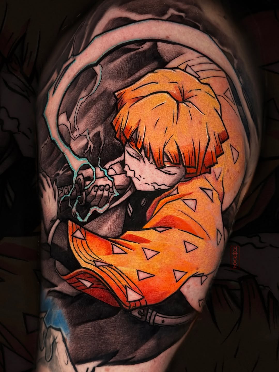 Colorful shoulder tattoo of a character with orange hair wearing a dinosaur costume, featuring detailed shading and vibrant orange and black ink.