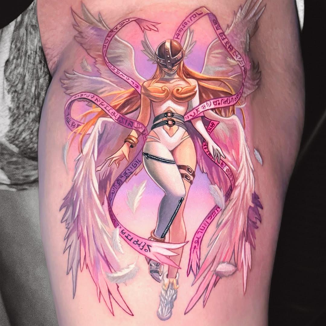 Winged armored figure with orange and gold tones surrounded by pink and purple feathered wings and flowing ribbons, tattooed on upper arm.