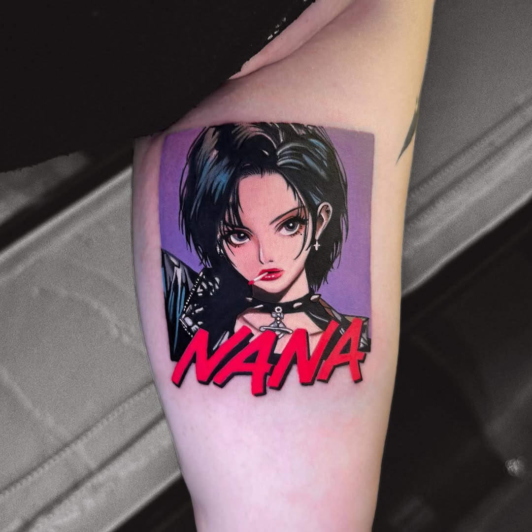Tattoo on upper arm featuring a portrait of a woman with short dark hair and red lips against a purple background, with red "NANA" text below.