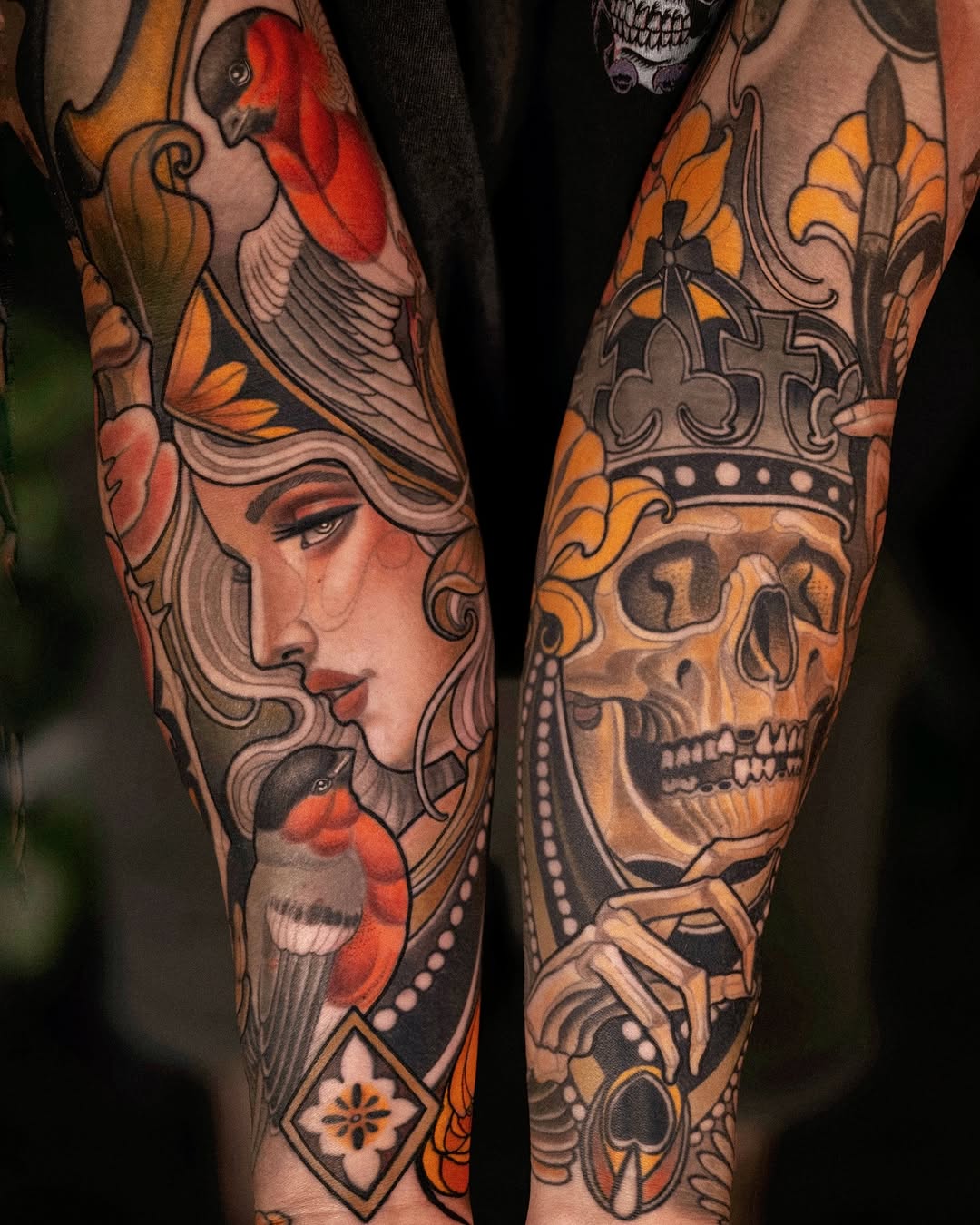 Pair of forearm tattoos featuring a woman's profile with red birds and ornamental crowns with skulls, rendered in orange, red, and black ink.