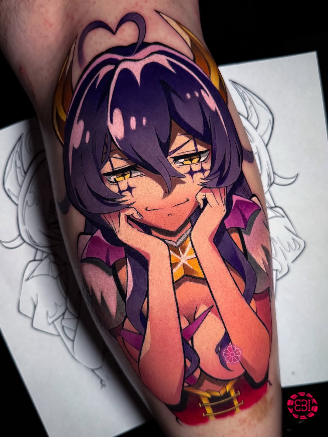 Colorful tattoo on upper arm featuring an anime-style character with purple hair, yellow eyes, and pink-red clothing, adorned with a heart symbol above.