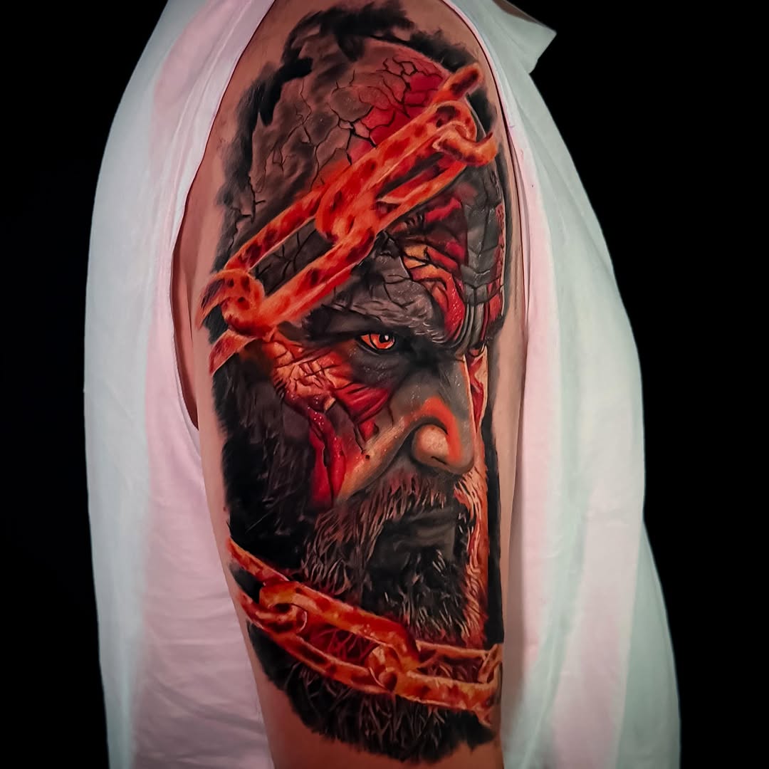 Bearded male face with glowing red energy streaks across the upper arm tattoo, featuring orange and dark tones.