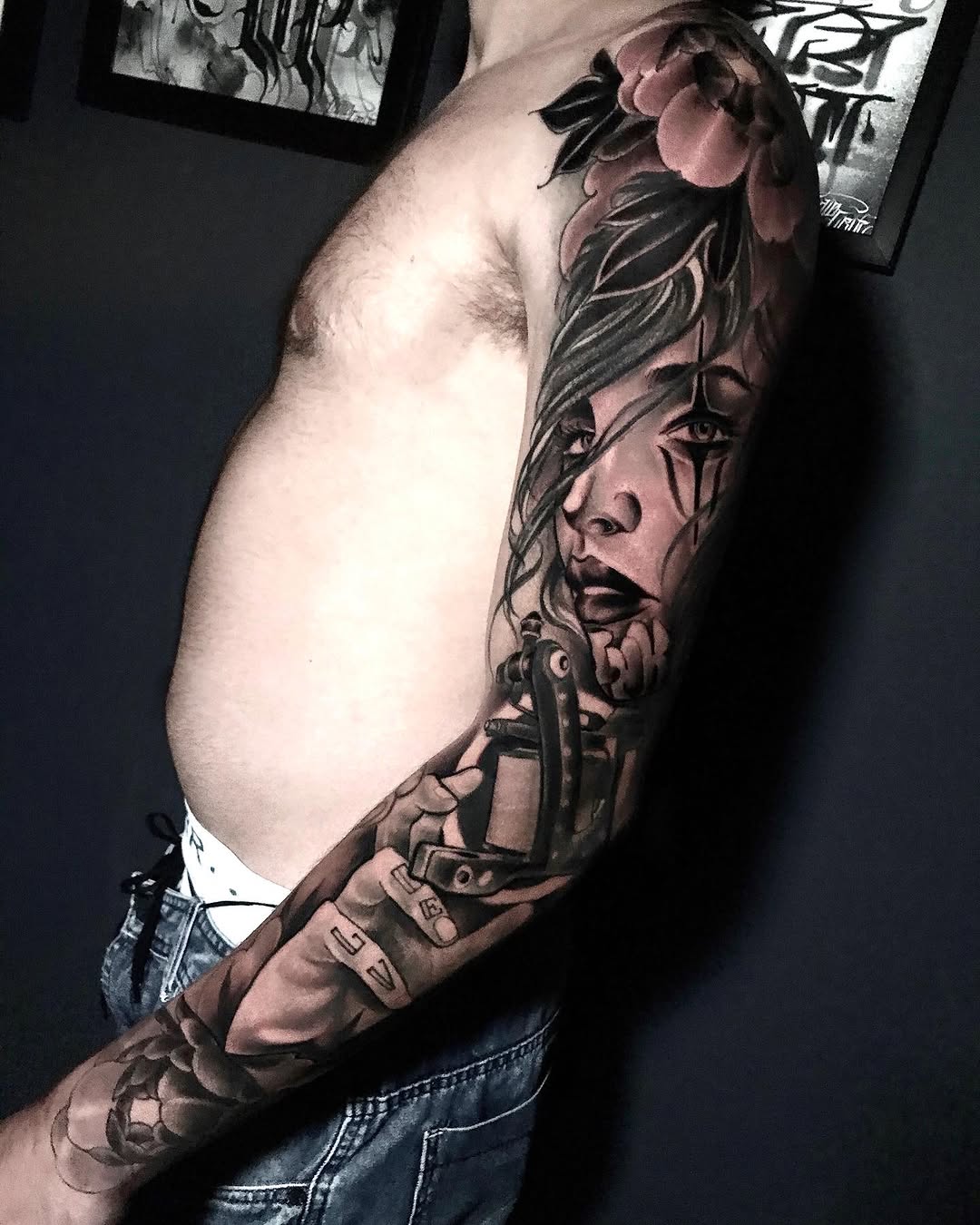Full-sleeve arm tattoo featuring a woman's face with flowing hair and a revolver, rendered in black and brown ink tones.