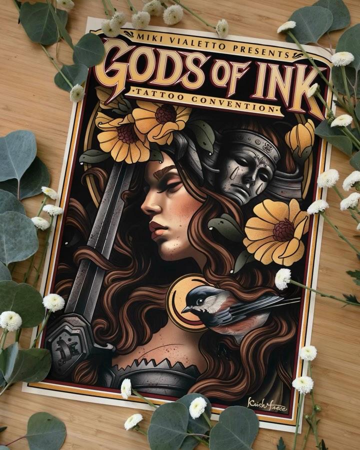 Poster for "Gods of Ink Tattoo Convention" presented by Miki Vialetto, featuring a woman with long brown hair, gold flowers, and a stone mask, surrounded by white flowers and green leaves.