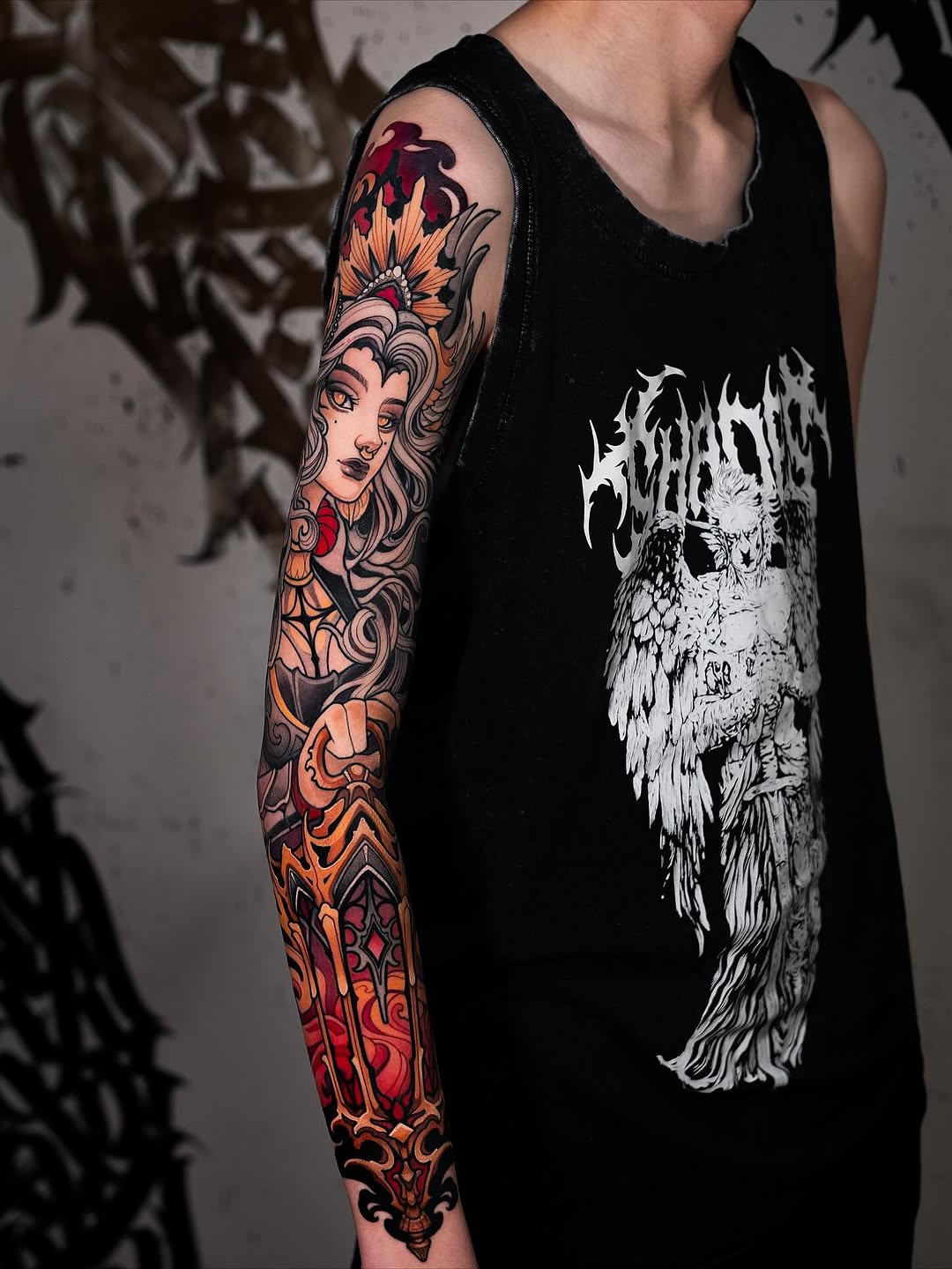 Full-sleeve arm tattoo featuring a woman's face with flowers above, ornate scrollwork, and red hearts on skin with warm orange and red tones.