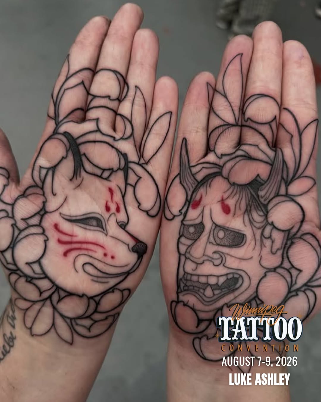 Two open palms display matching demon face tattoos with floral elements, red accents, and detailed linework in black and red ink.