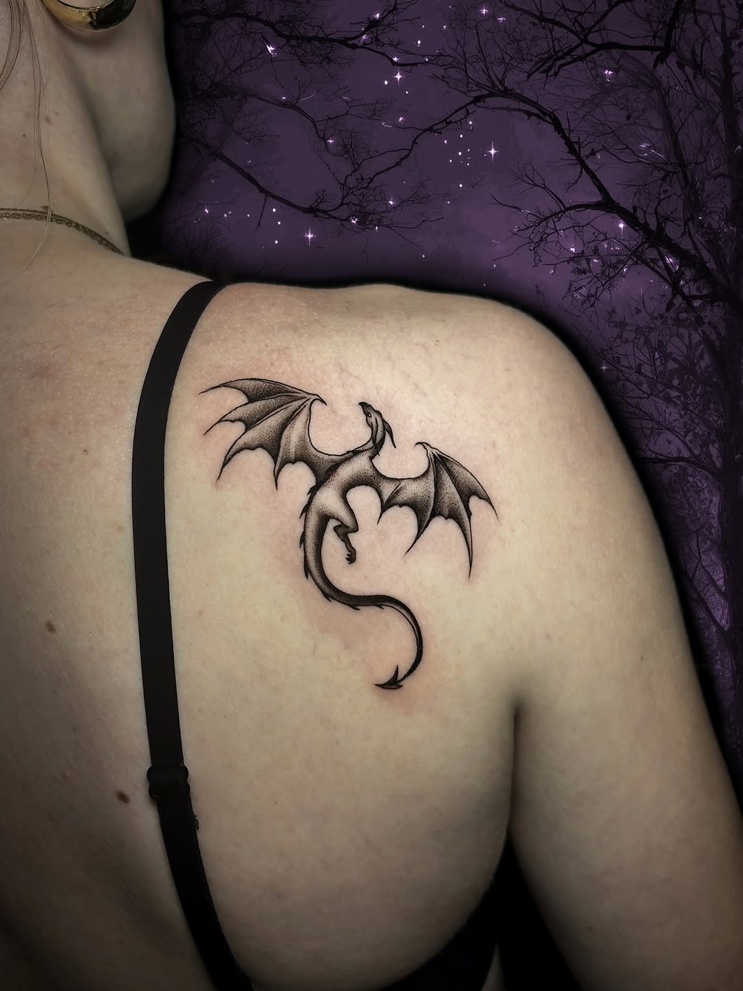 Winged demon creature tattoo on thigh with detailed shading and line work in black ink.