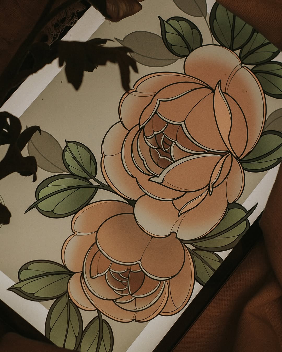 Two full-bloom roses with layered petals in peach and coral tones, surrounded by green leaves with black outlines on white paper.