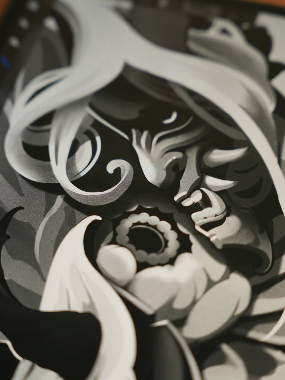 Ornate skull with flowing hair and decorative swirls holding a gear, rendered in white and gray tones on dark skin.