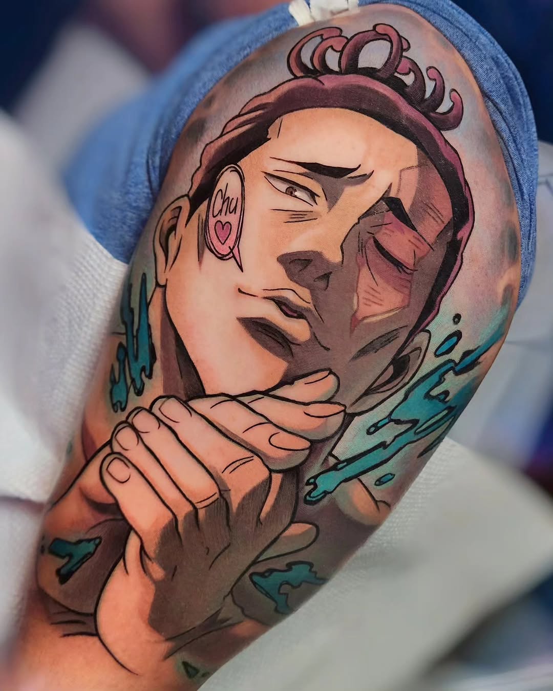 Colorful shoulder tattoo depicting a stylized female face with closed eyes, hoop earring, and flowing hair, accented with turquoise watercolor splashes.