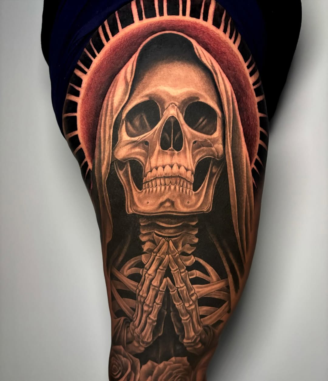 Skeletal figure wearing a hooded robe with exposed vertebrae and hand bones, rendered in warm brown and orange tones on the leg.