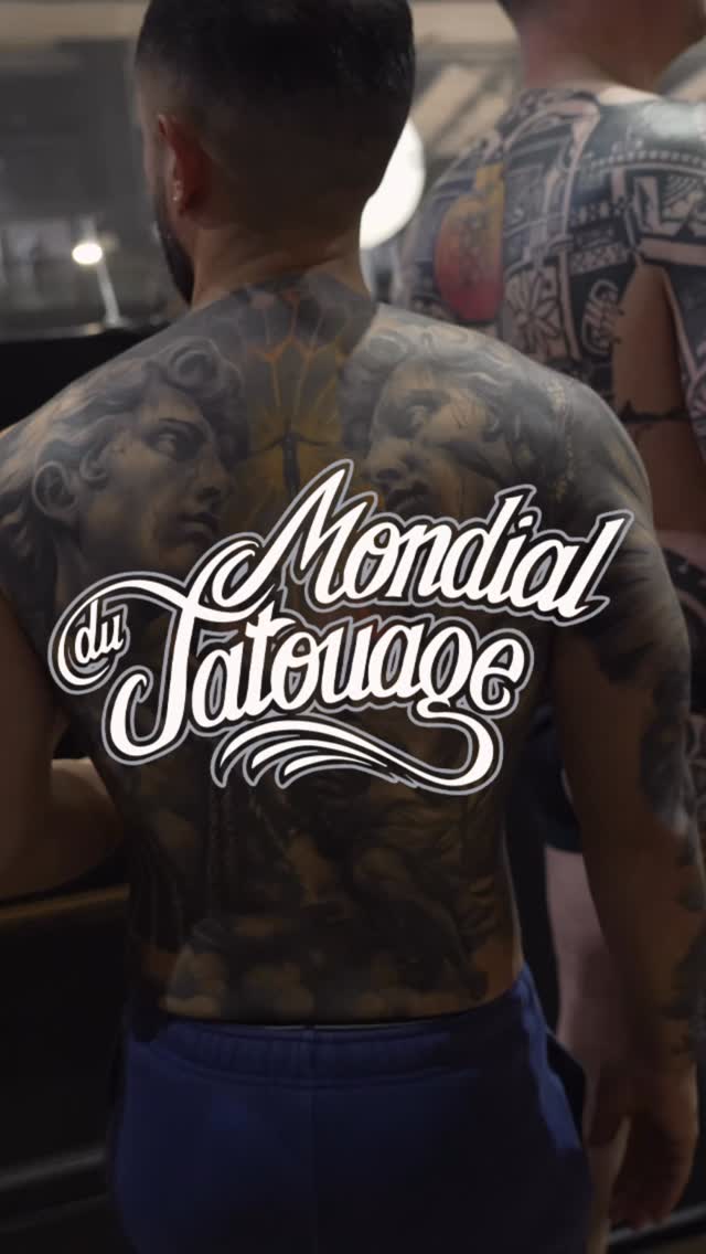 Back tattoo featuring classical bust portraits and ornamental designs in gray and black ink on male client's upper back.