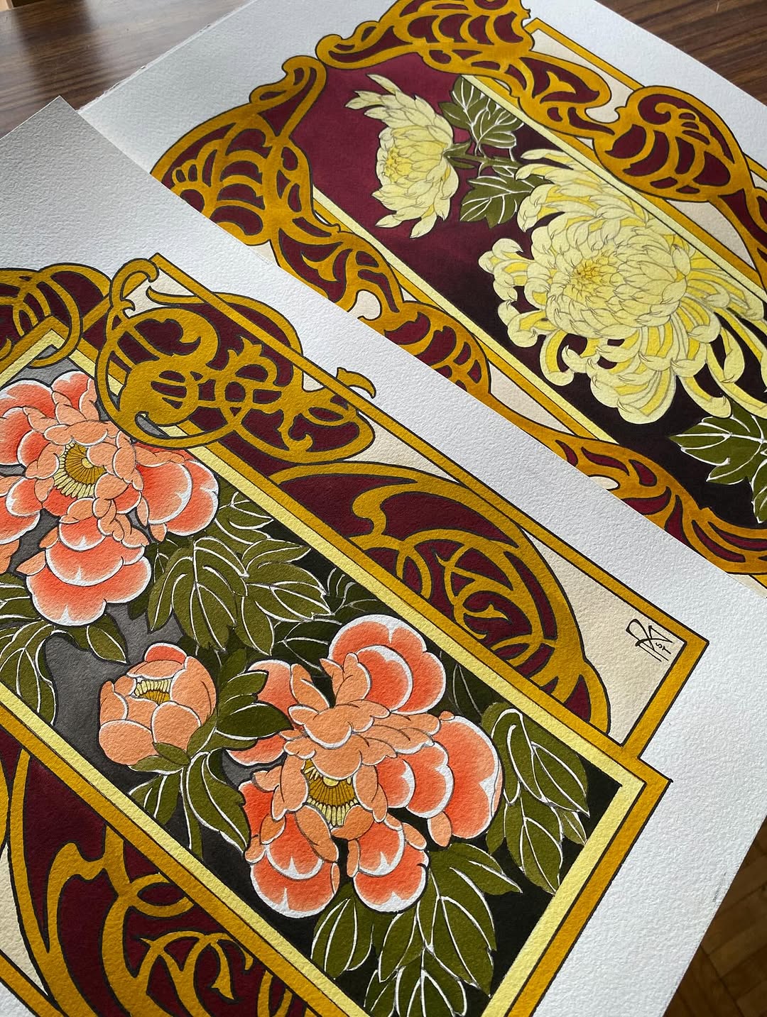 Two ornate floral designs featuring coral and yellow peonies with gold decorative borders and burgundy backgrounds on white paper.