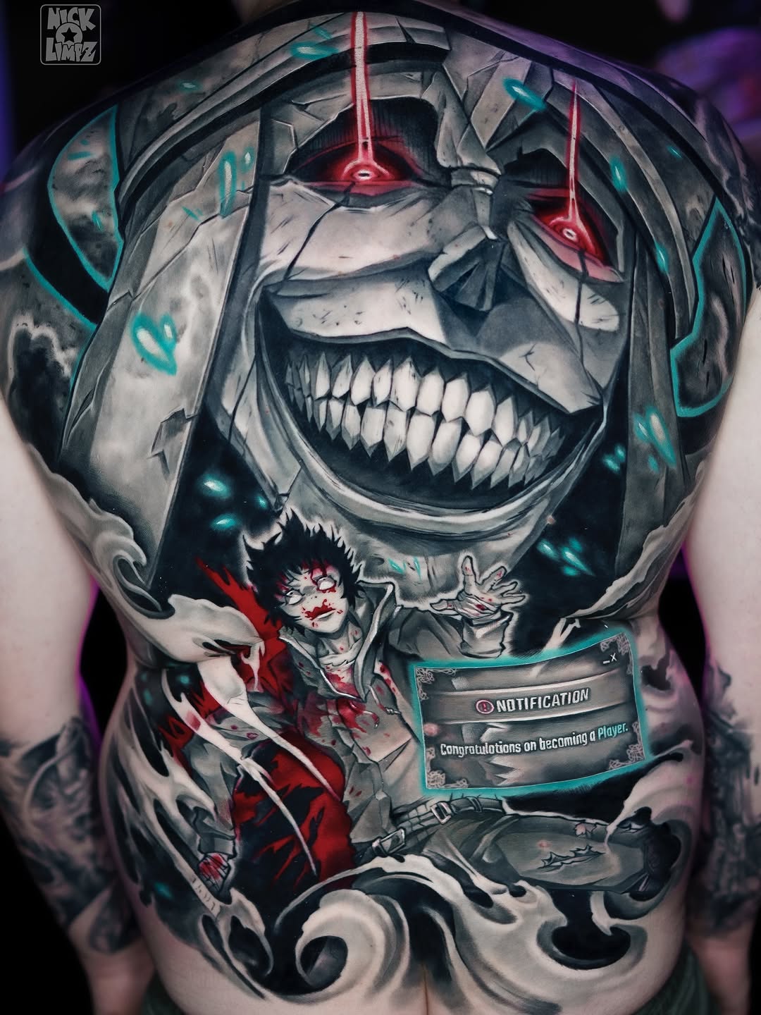 Large-scale skull with glowing red eyes and cyan accents, featuring a small female figure in red below, displayed on upper back/shoulder area.