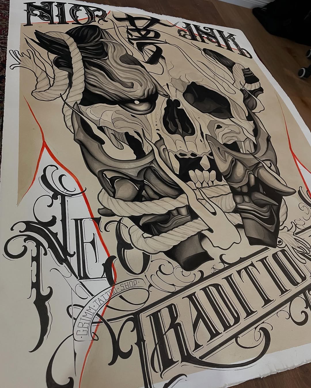 Detailed skull with horns and flowing hair design sketch in black ink and red accents on white paper, featuring ornamental scrollwork elements.