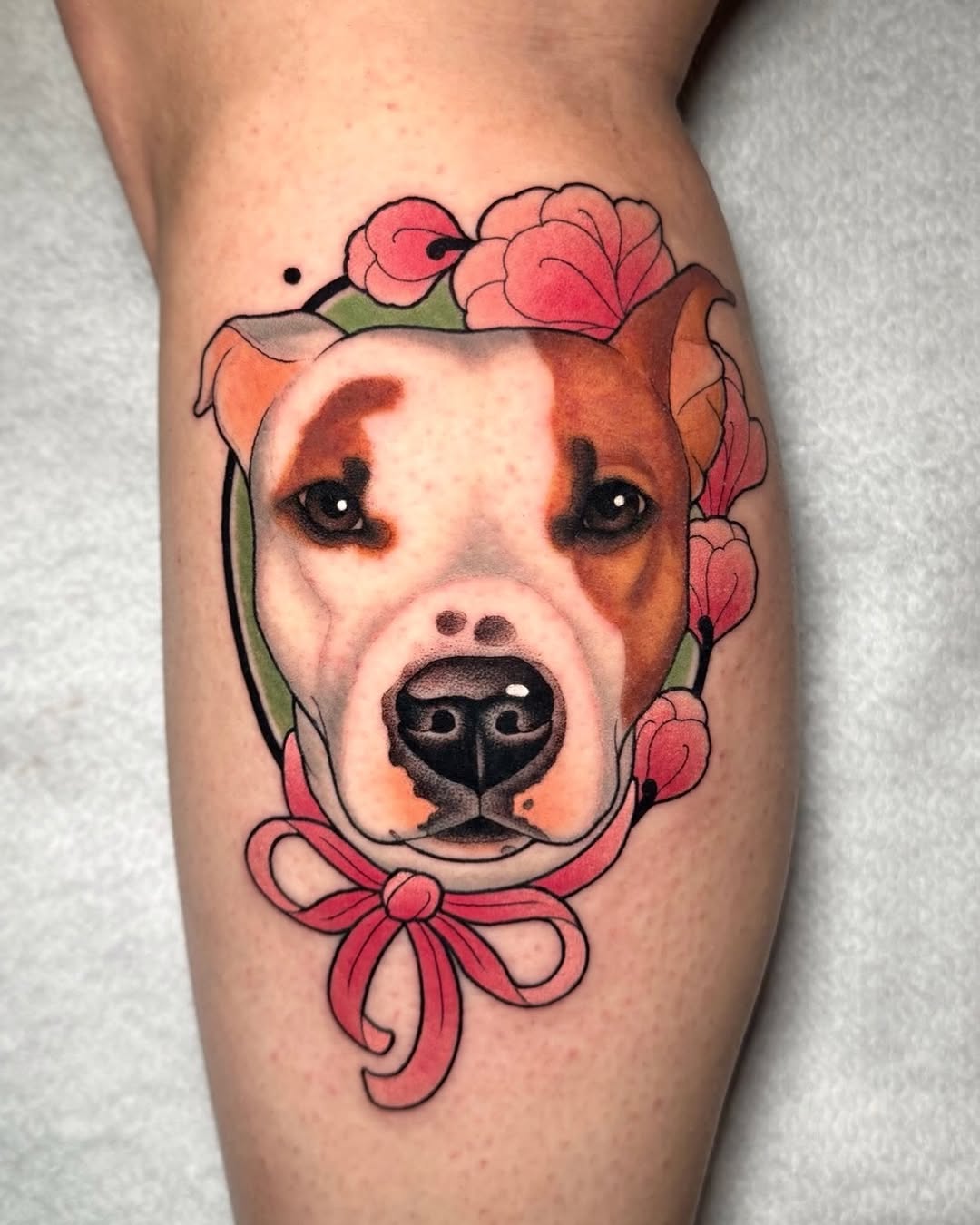 Dog's head portrait framed by pink flowers and a red bow on the calf, featuring brown and white coloring with black outlines.
