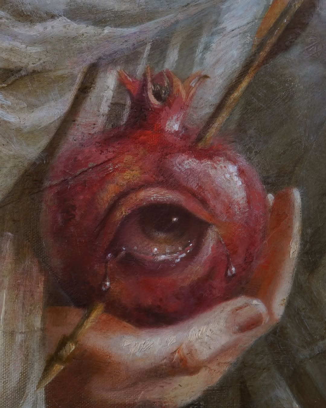 Red pomegranate with open crown and seeds held in hands against neutral background, displayed on what appears to be a portfolio canvas.