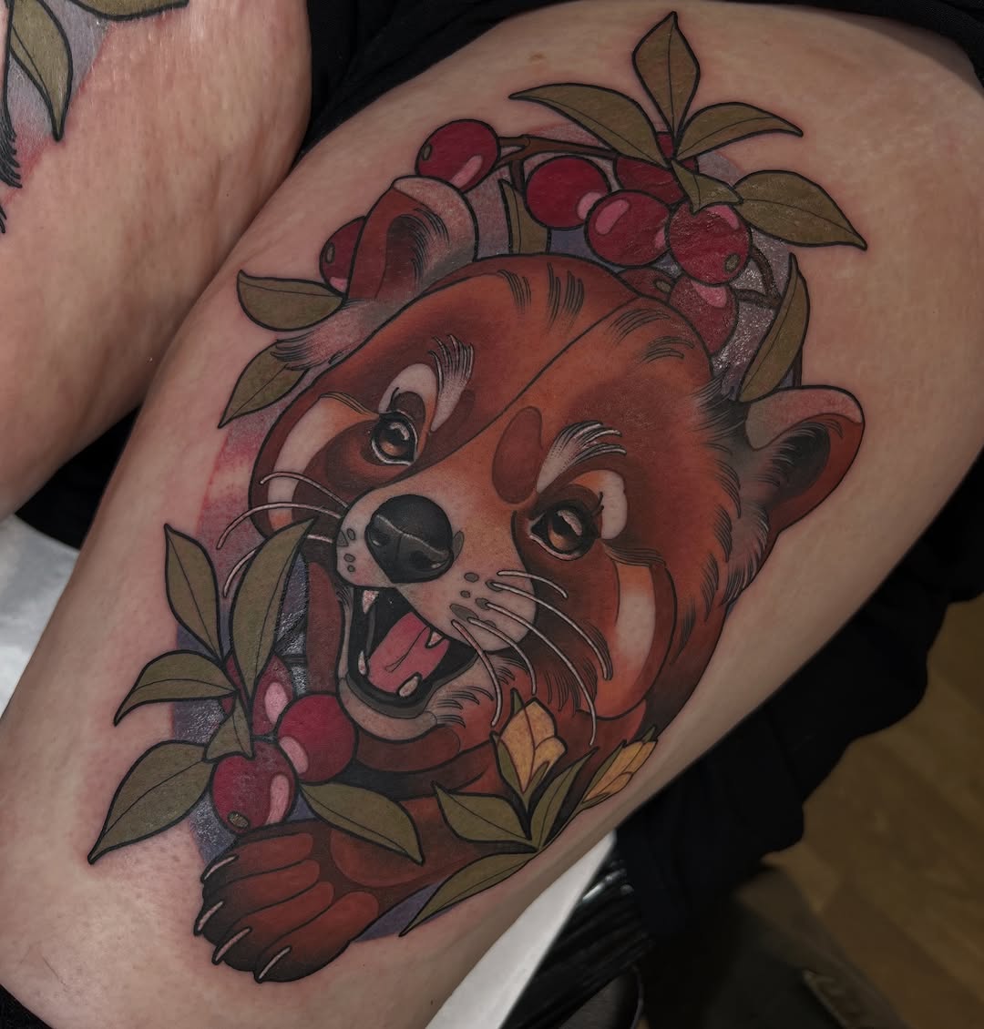 Red fox head with berries and leaves adorning its crown, tattooed on the upper arm with warm earth tones and detailed shading.