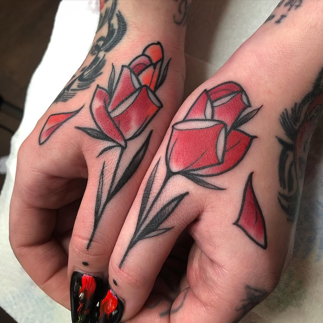 Two hands with matching red roses outlined in black with green leaves, featuring shading and color detail.