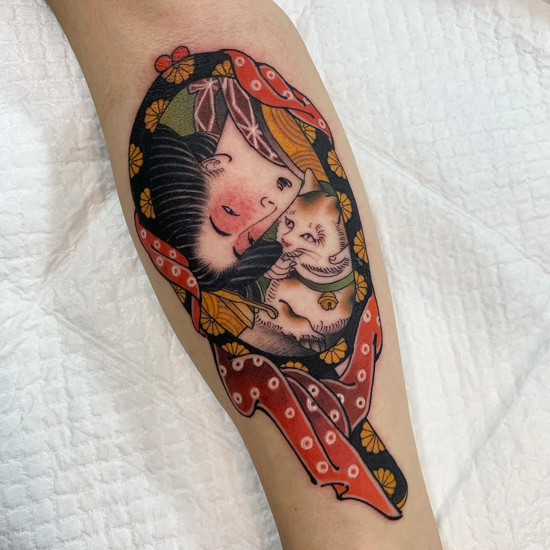 Woman's forearm tattoo featuring a mother and child's faces surrounded by red fabric with golden flowers and green accents.
