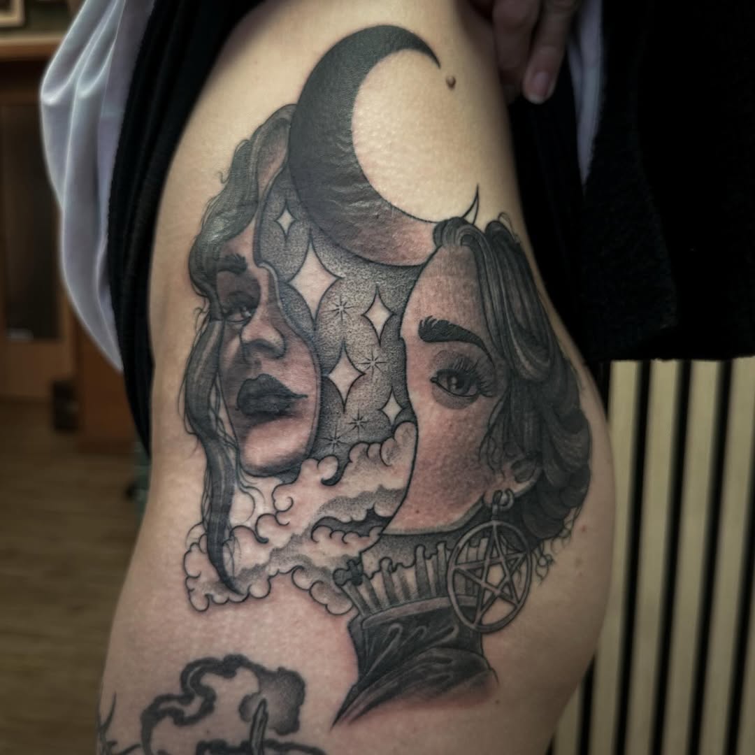 Two female faces in profile merge with celestial and mystical symbols including a crescent moon, stars, and a pentagram on the upper arm.