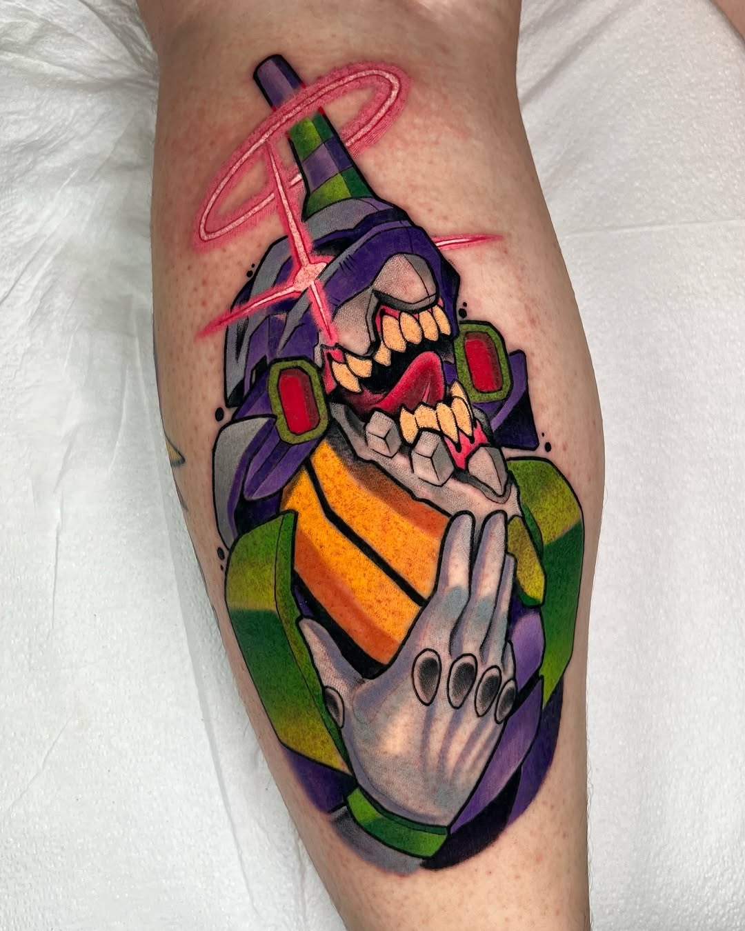 Colorful skull tattoo on a calf wearing a purple witch hat and holding an orange potion bottle, accented with pink neon lines.