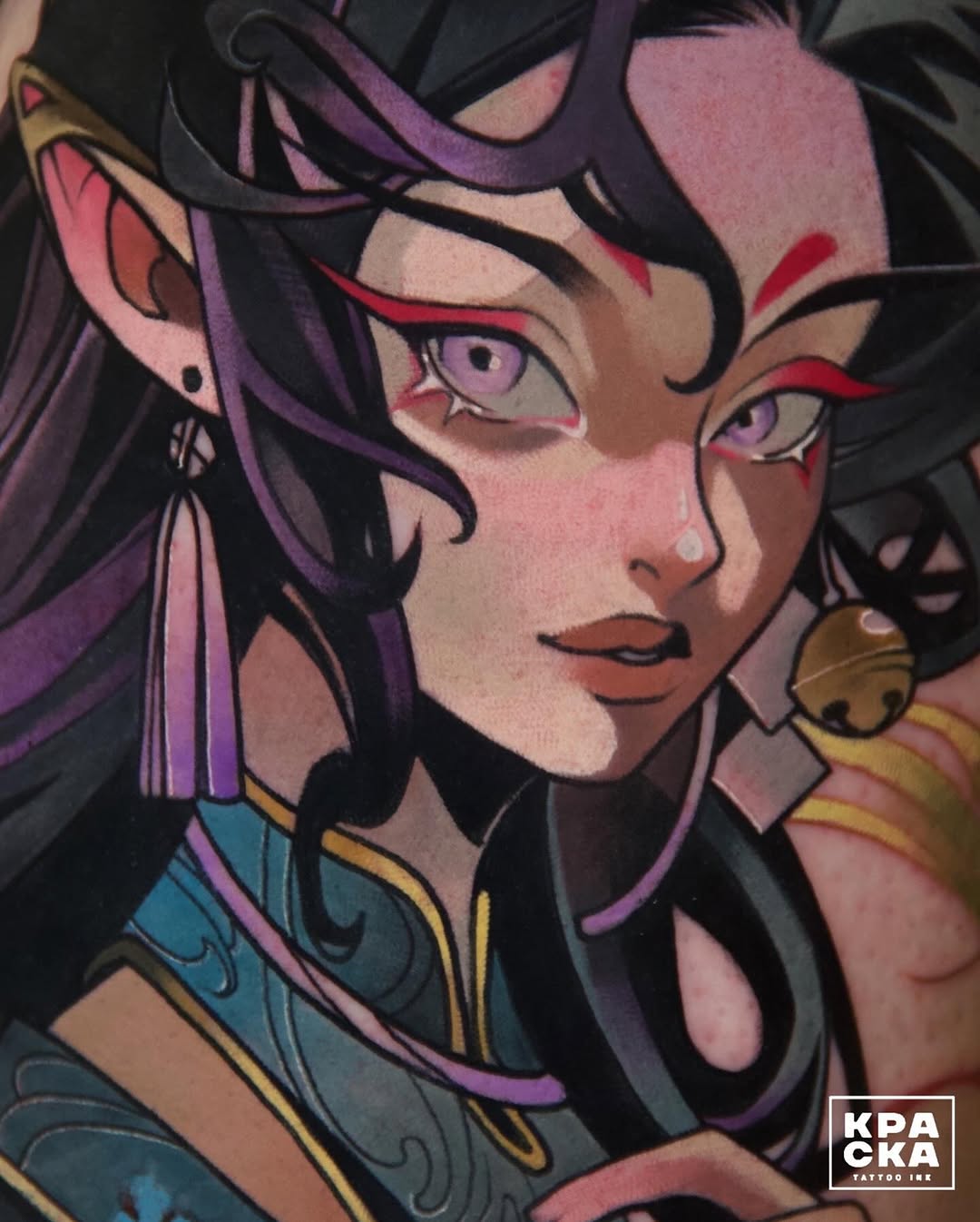 Colorful portrait tattoo featuring a woman with purple hair, red facial markings, and gold jewelry against a dark background.
